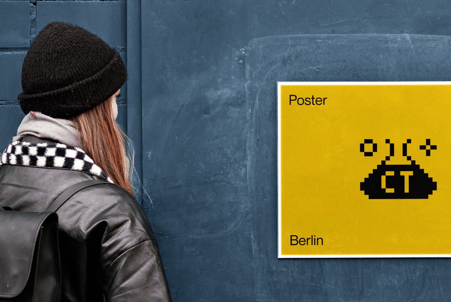 Woman viewing a pixel-art poster mockup on a wall, urban setting, ideal for graphic design display.